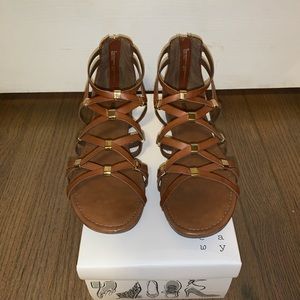 Tan strappy sandal with gold accents.